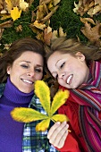 Mother and daughter with autumn leaf
