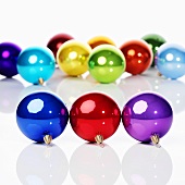 Shiny, coloured Christmas baubles in rows