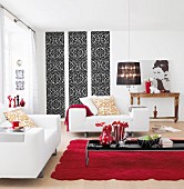 A living room in white with touches of red and black