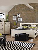 White double bed and chests of drawers in bedroom with stone-effect wallpaper, black and white rug and roof beam