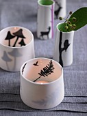 Porcelain tealight holders decorated with silhouettes