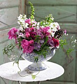 A luxuriant bunch of summer flowers in a porcelain bowl