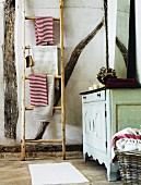 Vintage bathroom with wooden ladder as towel rack