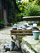 Candles in zinc cups on a stone wall