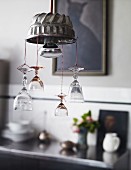 Lamp hand-crafted from cake mould decorated with suspended crystal glasses