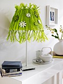Lamp with lampshade hand-crafted from green raffia & wooden flowers