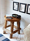 Hand-crafted, wooden stool used as side table