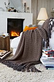 A knitted woollen throw with a criss-cross pattern