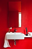 Sink in guest toilet painted vivid red