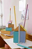 Pastel-painted building blocks as letter and pen holders