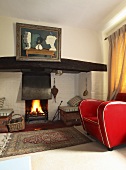 A fire burning fireplace in the living room of an English country house