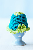 A crocheted egg cosy on top of an egg
