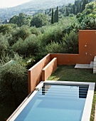 View of a pool and an outdoor shower in the designed garden in a Mediterranean landscape