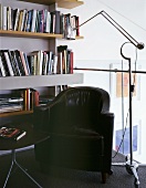 Cozy reading corner with antique leather armchairs and chrome floor lamps in retro style