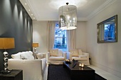 Elegant living room with upholstered seating and designer pendant lamps with shaded chandeliers