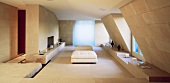 Minimalist living room under a roof with ottomans upholstered in white and stone tiles on the wall and floor