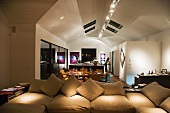 Cushions on an upholstered sofa in a modern open-plan living room-cum-dining room