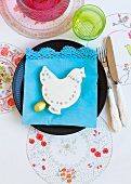 A place setting decorated with a chicken-shaped biscuit