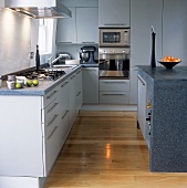 A white kitchen with granite work surfaces