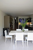 Bouquet on white dining table with metal frame in grey and black kitchen-dining room