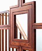 Beautifully crafted wooden frame of mirrored sliding door with reflection of staircase balustrade
