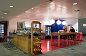 An open-plan, self-service cafe with bar furniture