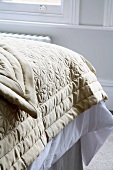 Light brown quilted blanket on bed