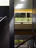 Open stairwell in contemporary house with interior and exterior views