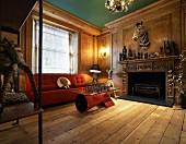 Animal trophies above fireplace in rustic, modern salon