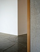 Wall corner and concrete floor with stylised joints in foyer