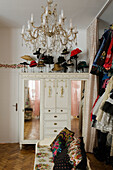 Vintage wardrobe and crystal chandelier, clothes rails