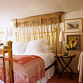 Bed with golden details and antique decorative beams in the bedroom