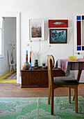 Dining area with vintage wooden furniture and green carpet