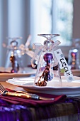 Upturned wine glass with Christmas decorations and name card