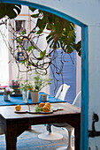 Dining area with rustic wooden table and hanging plants