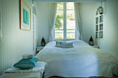 Bedroom with window and white curtains