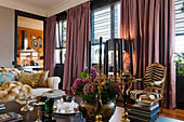 Living room with pink curtains and striped armchairs