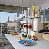 Brightly designed kitchen with colourful crockery and a view of the city