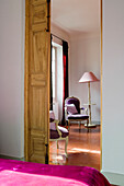 View of a room with baroque armchairs and floor lamp