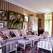 Living room with striped wallpaper and furniture, picture with horses and jockeys