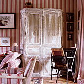 Vintage cupboard with patina, furniture and walls with stripes