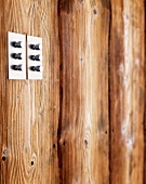 Stainless steel light switch knobs on wooden wall