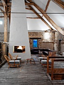 Rustic one-room house with fire in open fireplace