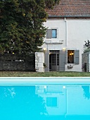 Swimming pool in front of simple house