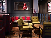 Mixture of seating styles with comfortable retro upholstery on worn fishbone parquet
