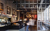 London coffee shop with floral mural and metal-framed partition