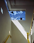 Stairwell with handrail and windows
