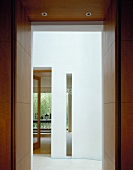 View through doorway into white foyer of contemporary house