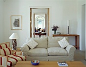 Light, upholstered sofa in plain living room