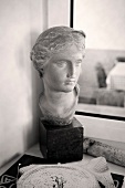Antique bust in front of window
